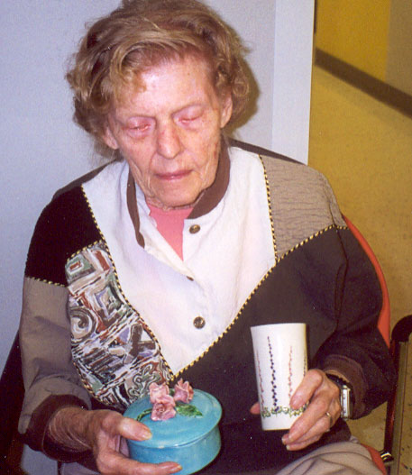 Jean at GuildCare showing ceramics she made in 1948